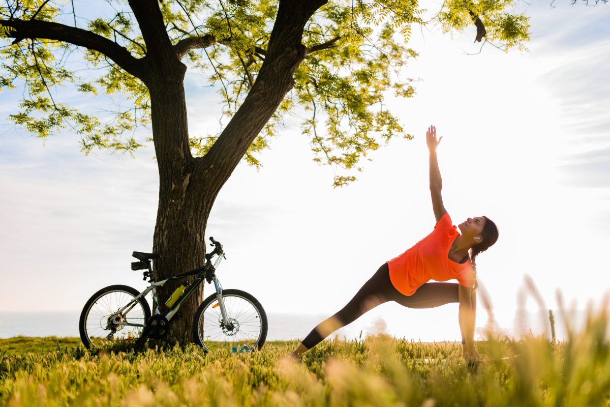 slim-beautiful-woman-silhouette-doing-sports-morning-park-doing-yoga-min